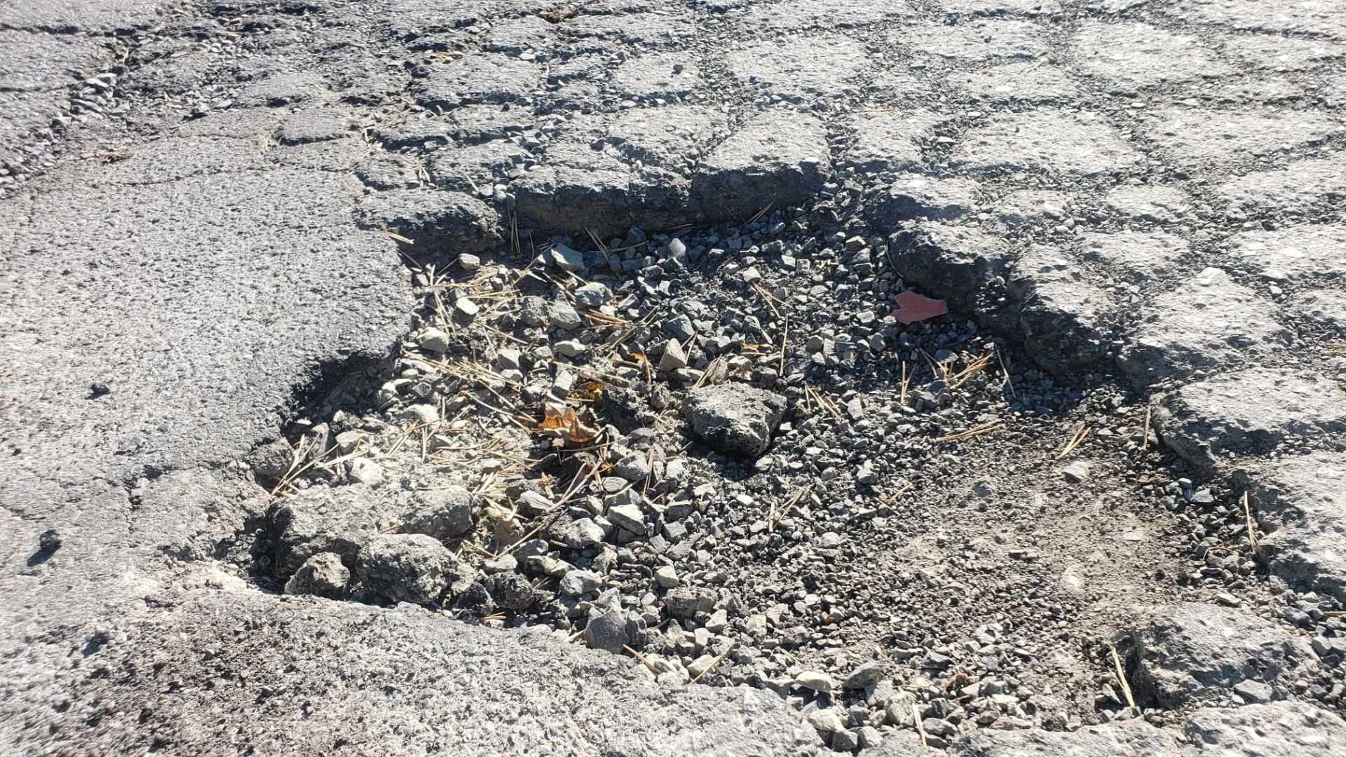 close up image of a pothole on a street,